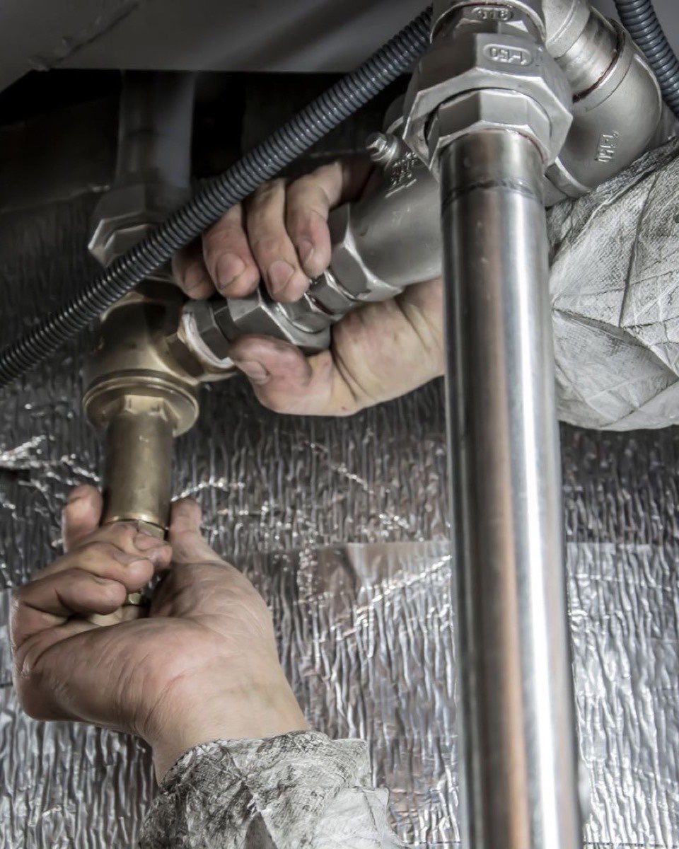 Plumbing work shown as an illustration.